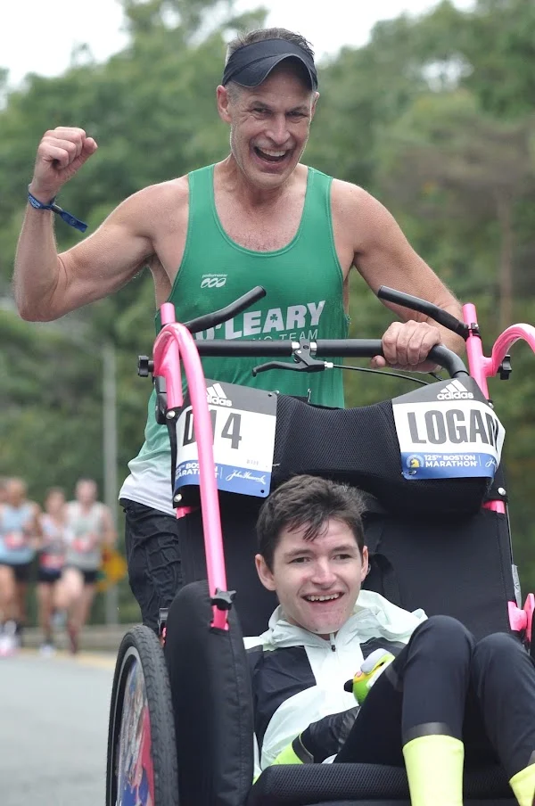 Runner pushing a racing chair during a road race
