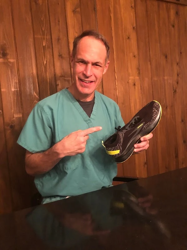 Dr. William Johncock holding a running shoe